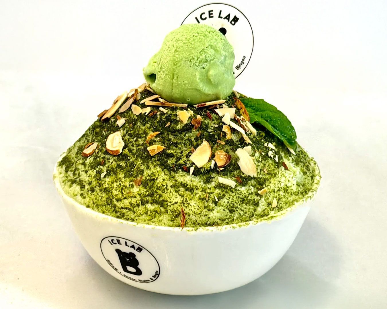 Finely shaved milk ice piled high and topped with fruit, sauce, and chewy toppings in a fluffy mountain-like form.