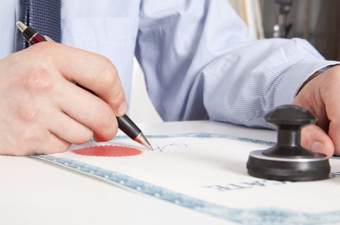 Man Signing a Paper - Escrow Company in Lakewood, CA