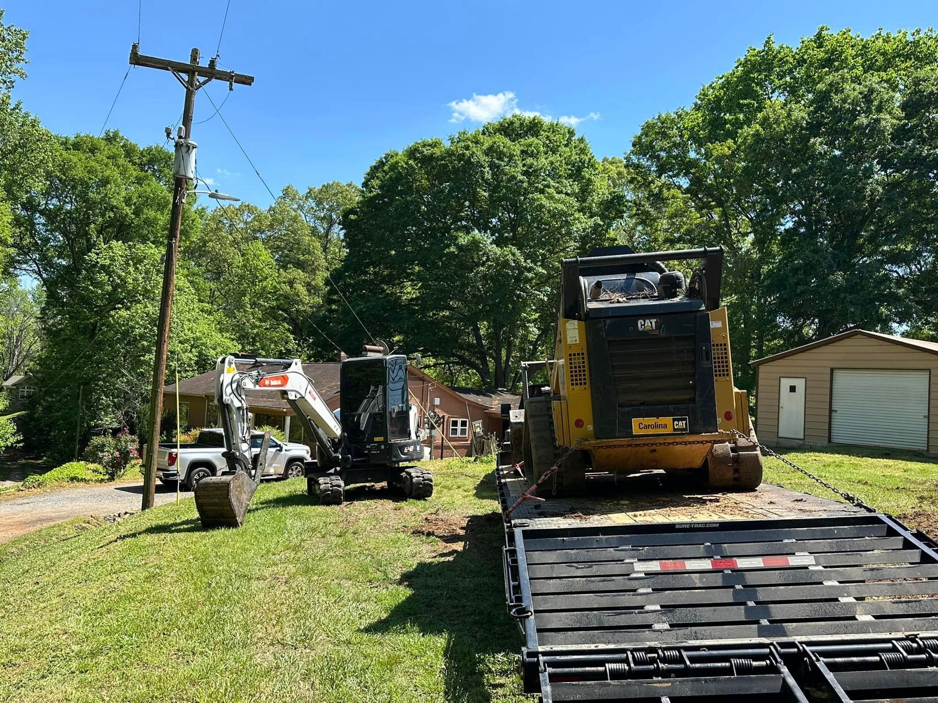 A bulldozer is sitting on top of a flatbed trailer.