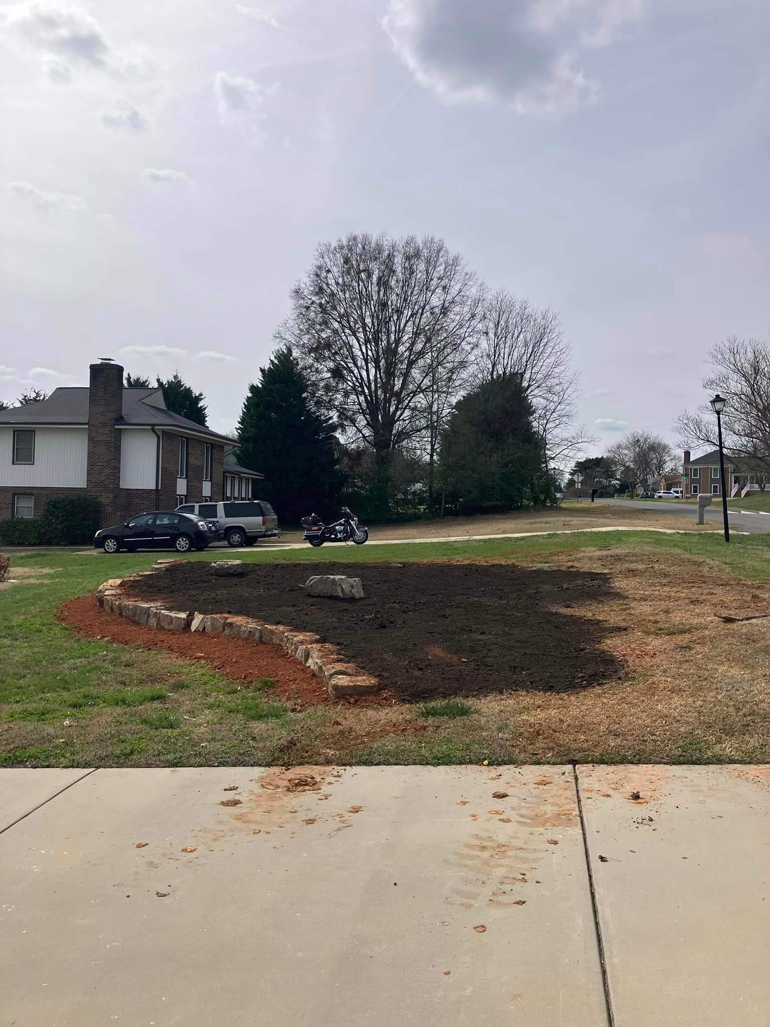 There is a lot of dirt in the middle of the yard.
