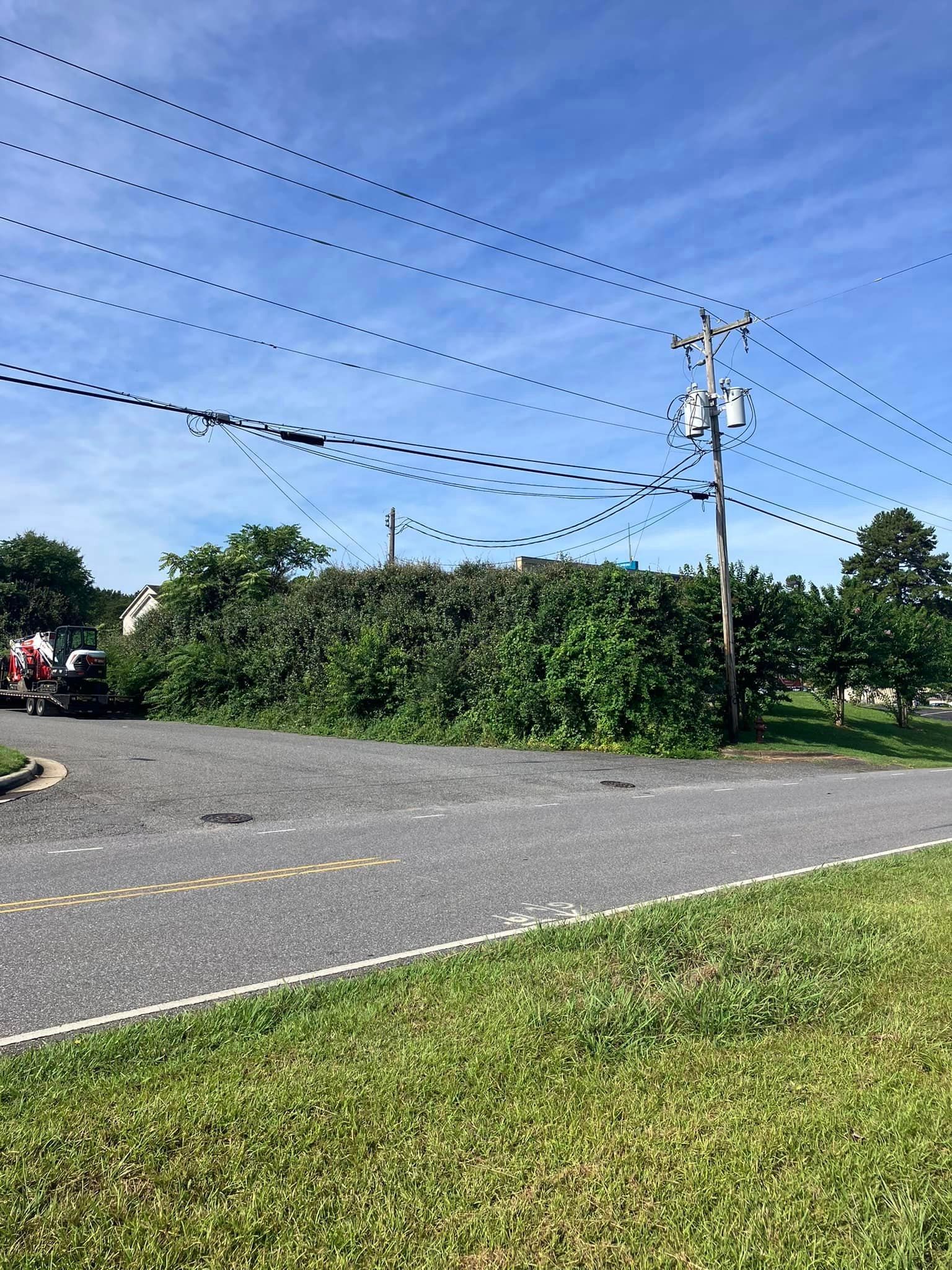 A truck is parked on the side of the road next to a telephone pole.