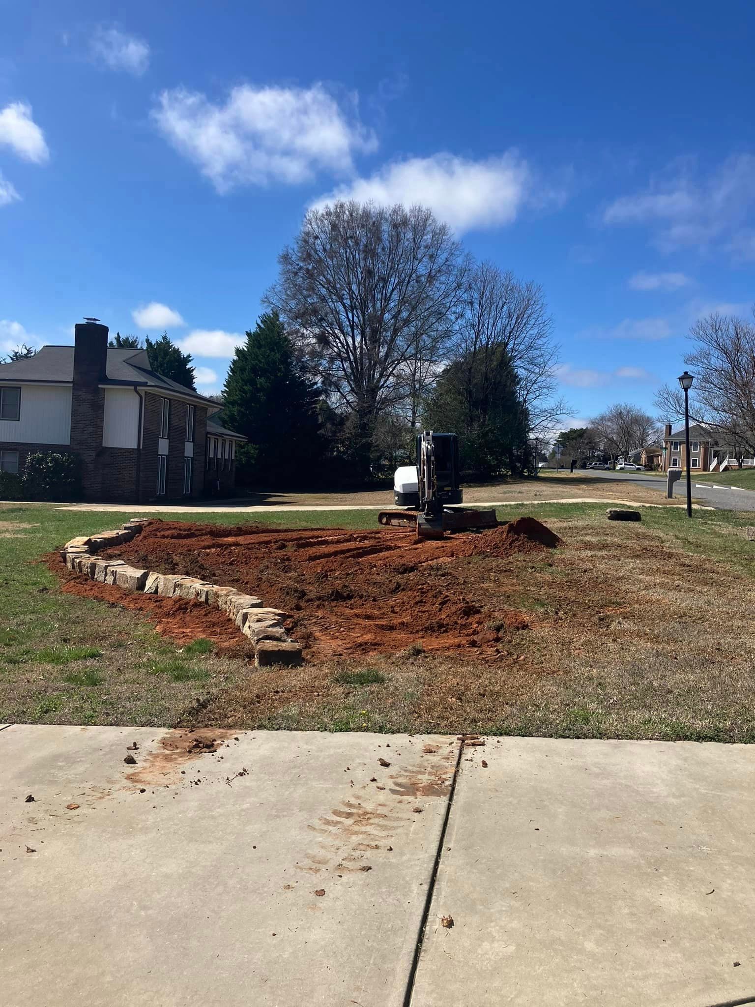A large pile of dirt is sitting on the sidewalk in front of a house.
