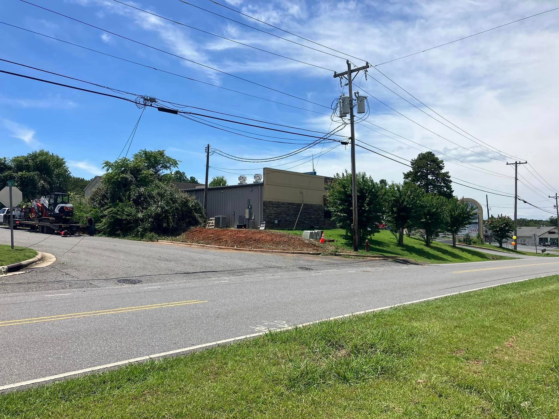 There is a lot of power lines on the side of the road.