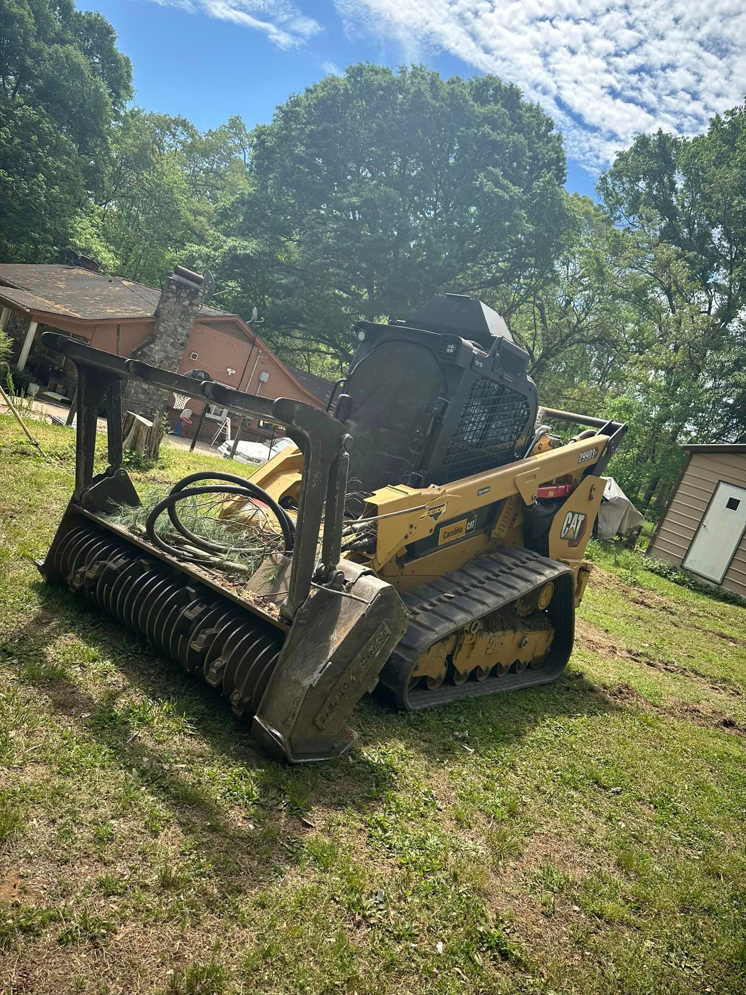 A bulldozer is sitting on top of a lush green field.
