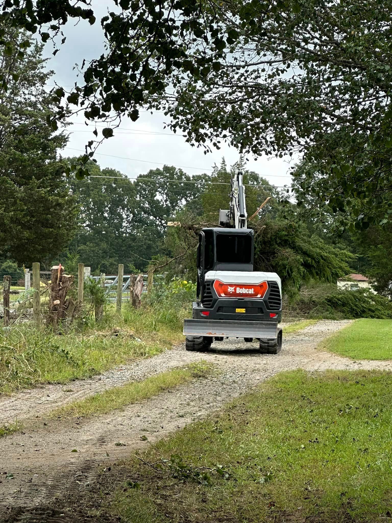A bulldozer is driving down a dirt road.