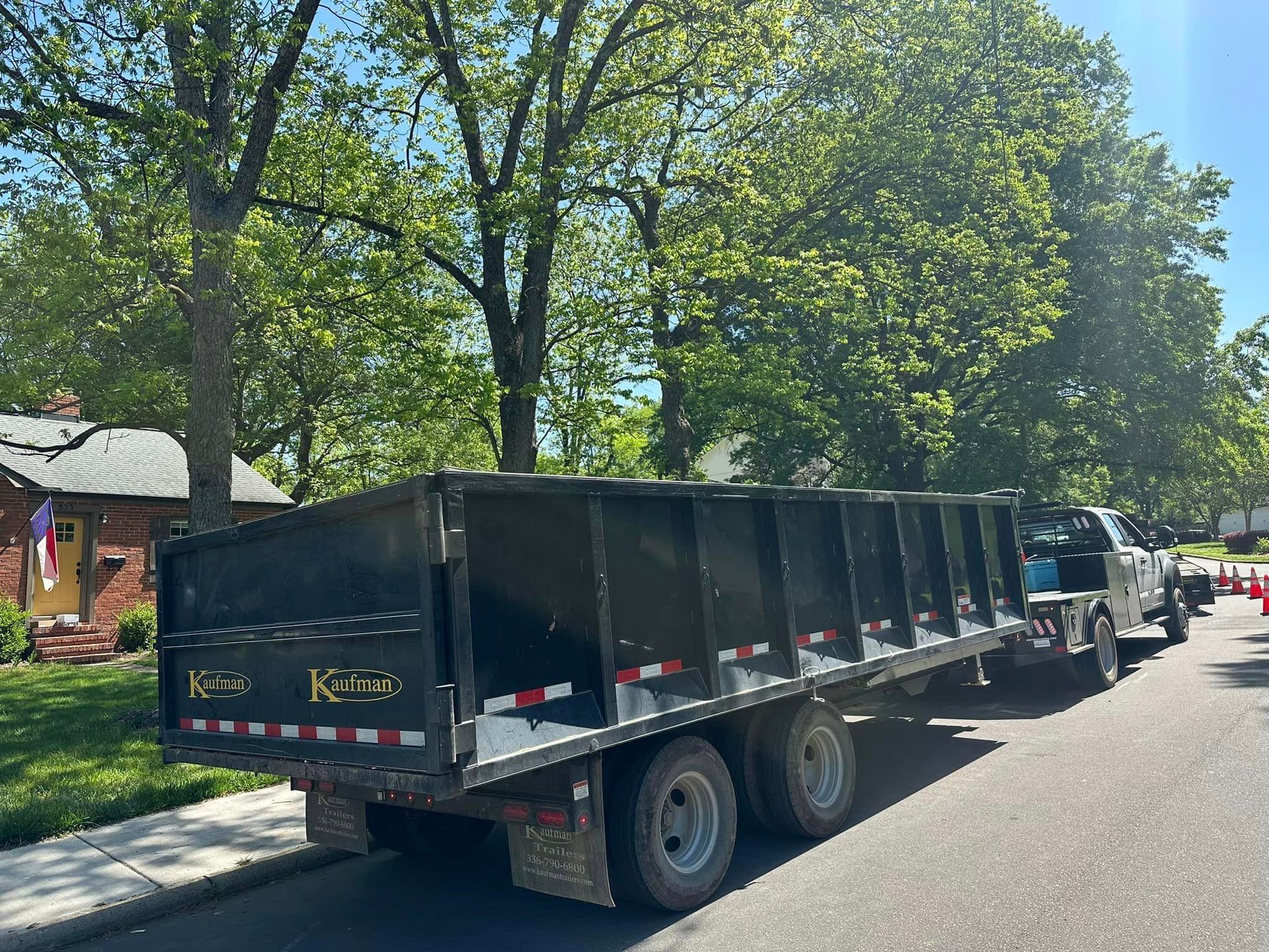 A dump truck is parked on the side of the road.