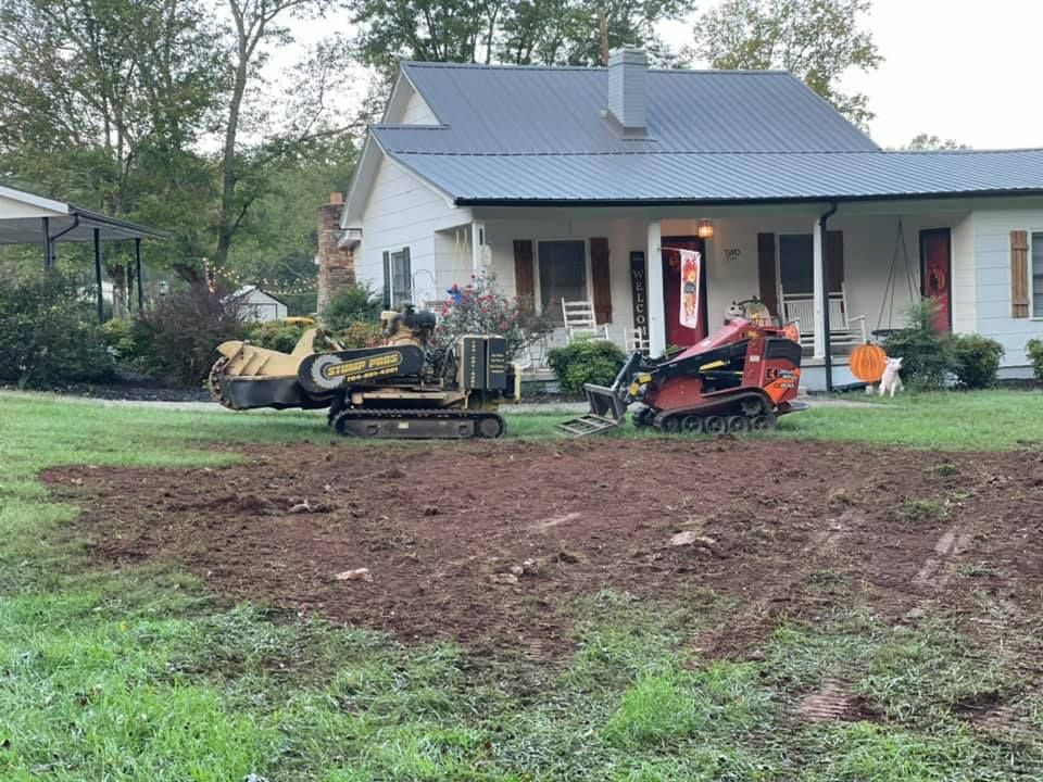 A house with a stump grinder in front of it