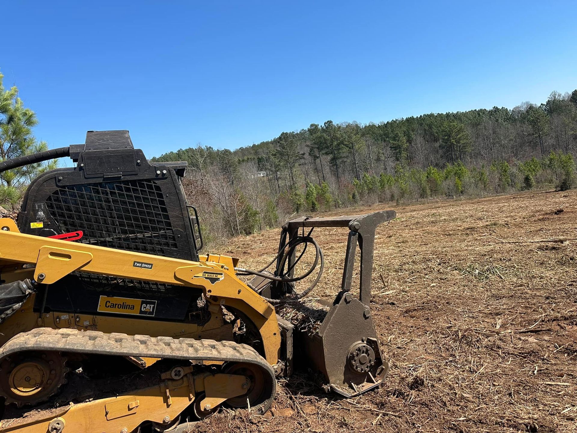 A bulldozer is sitting in the middle of a field.