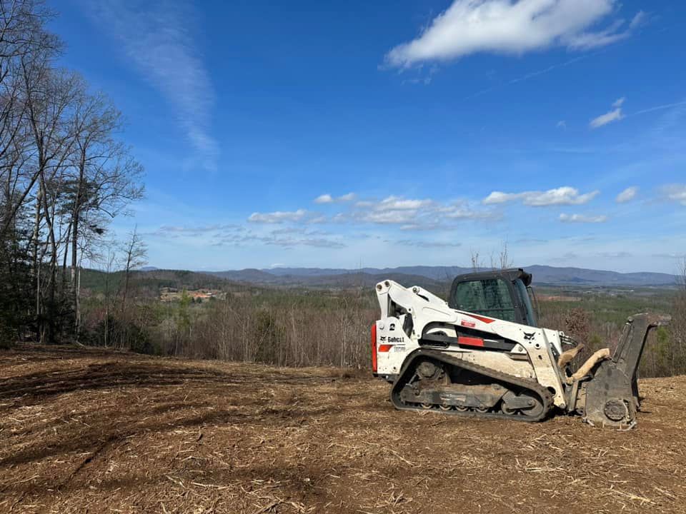 A bulldozer is sitting on top of a dirt field.