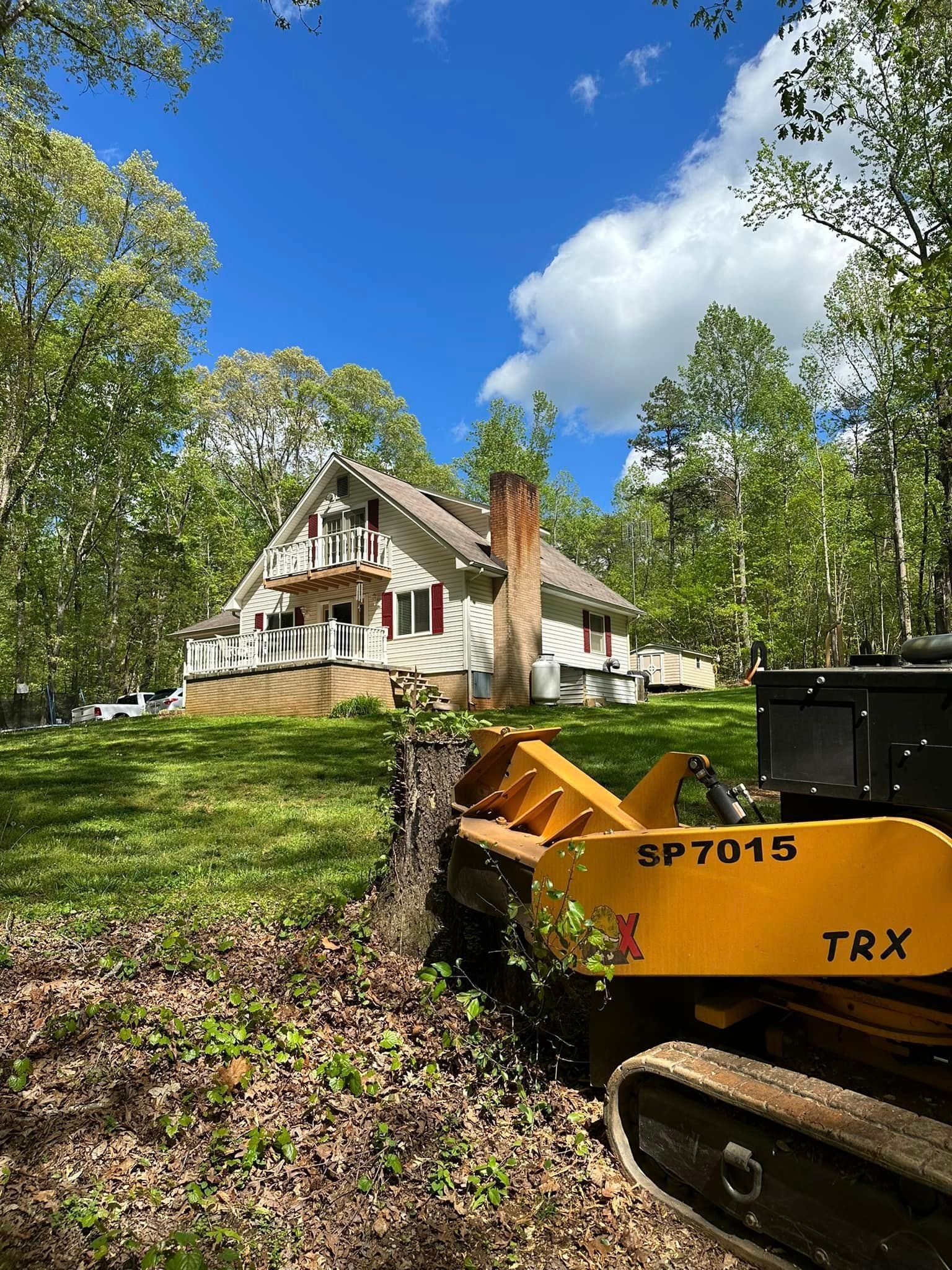 A yellow tractor is parked in front of a house.