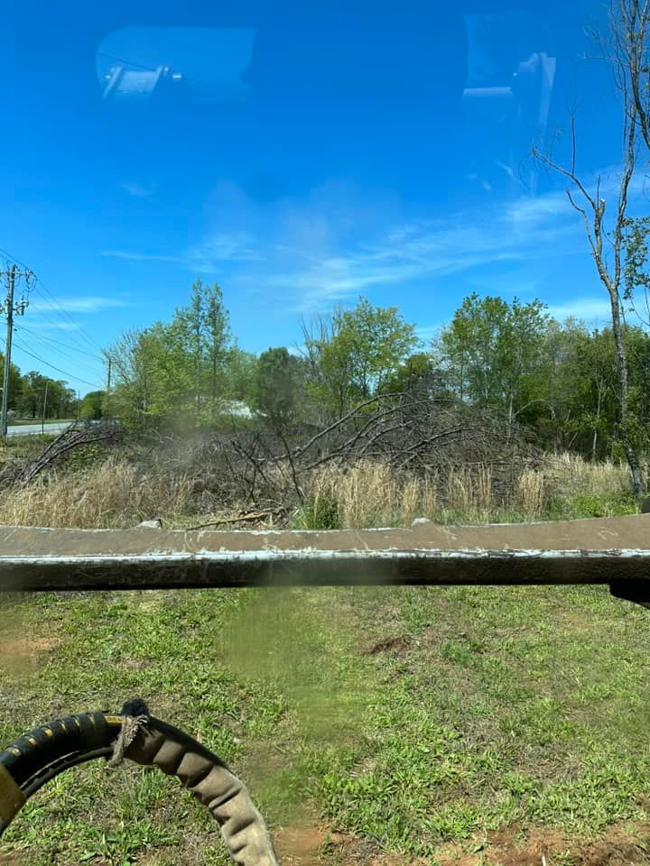 A view of a field through a window of a truck.