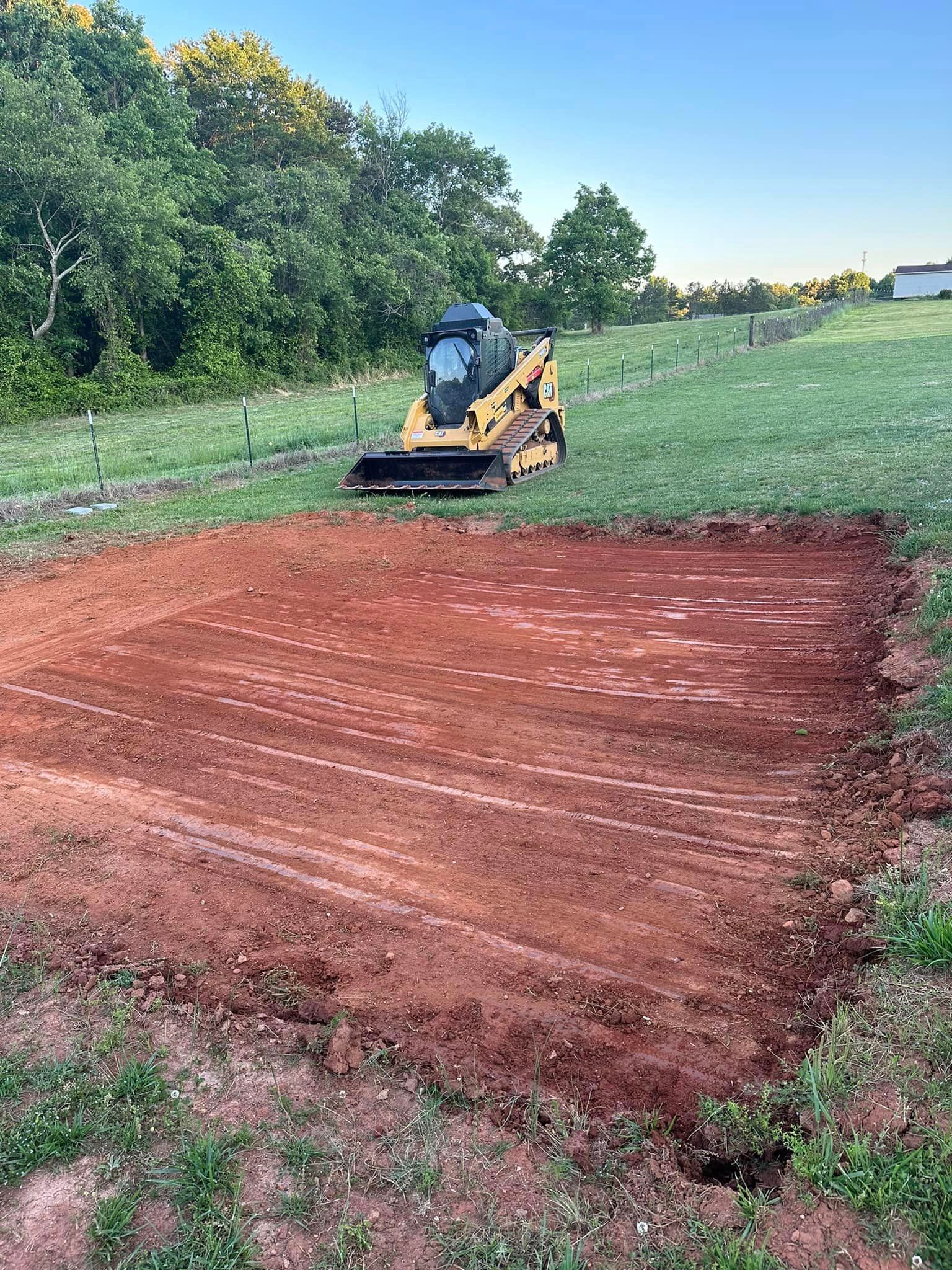 A bulldozer is moving dirt in a field.