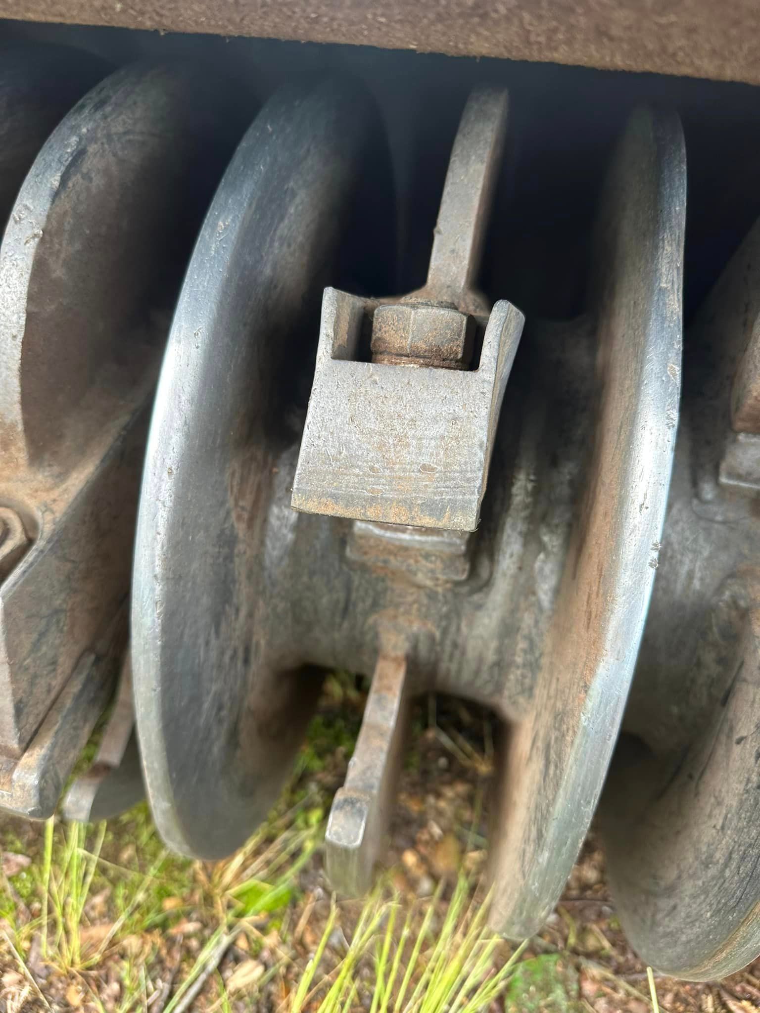 A close up of a metal object on the ground.