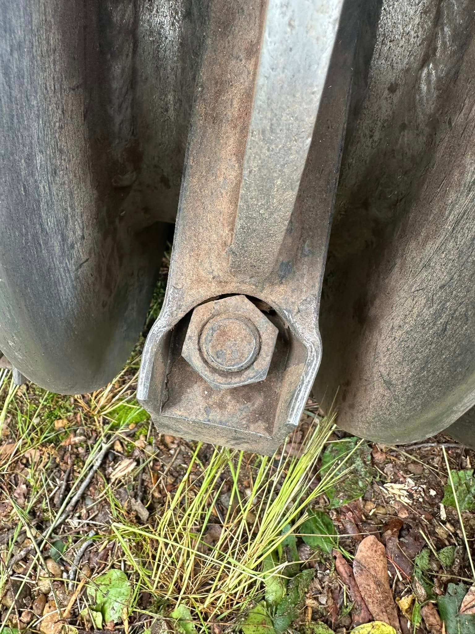 A close up of a metal object with a nut in it.