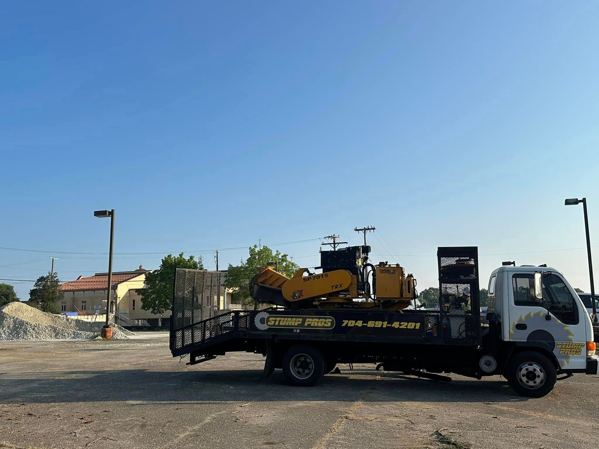 A tow truck with a tractor on the back of it