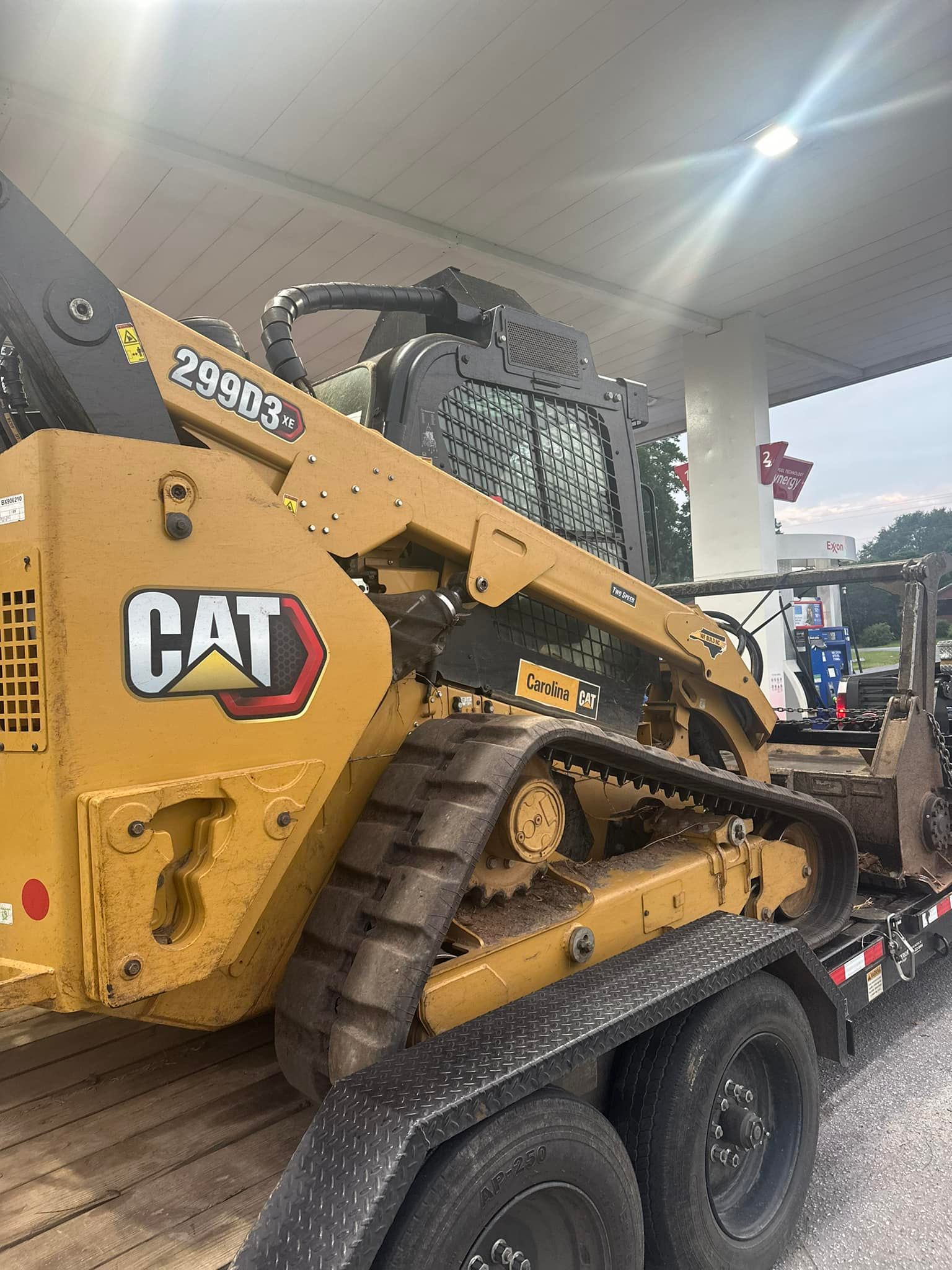 A cat bulldozer is sitting on top of a trailer.
