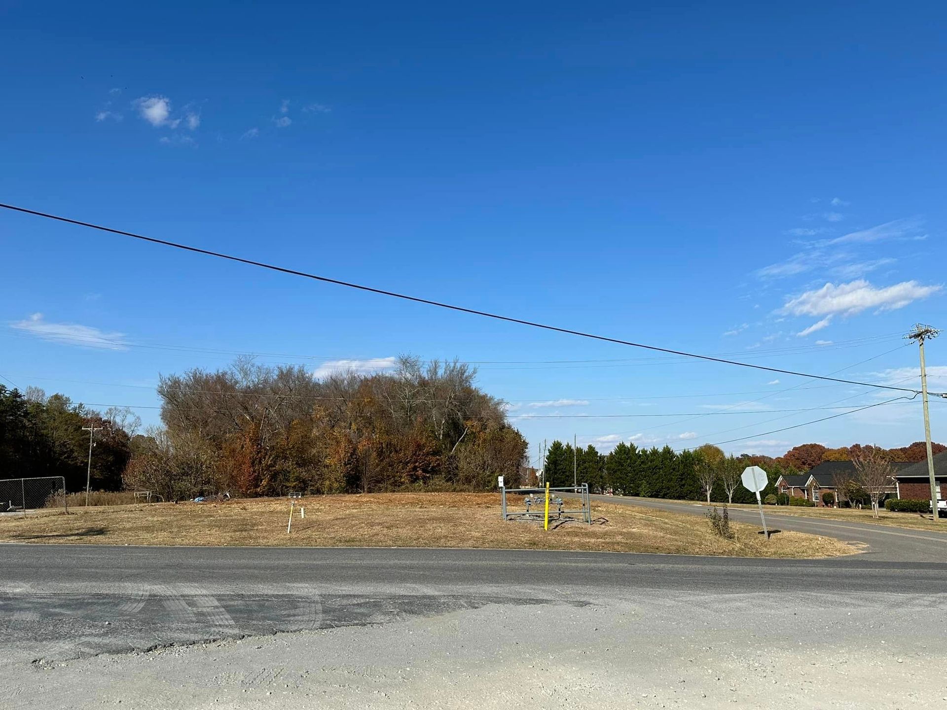 There is a lot of power lines going through the middle of the road.