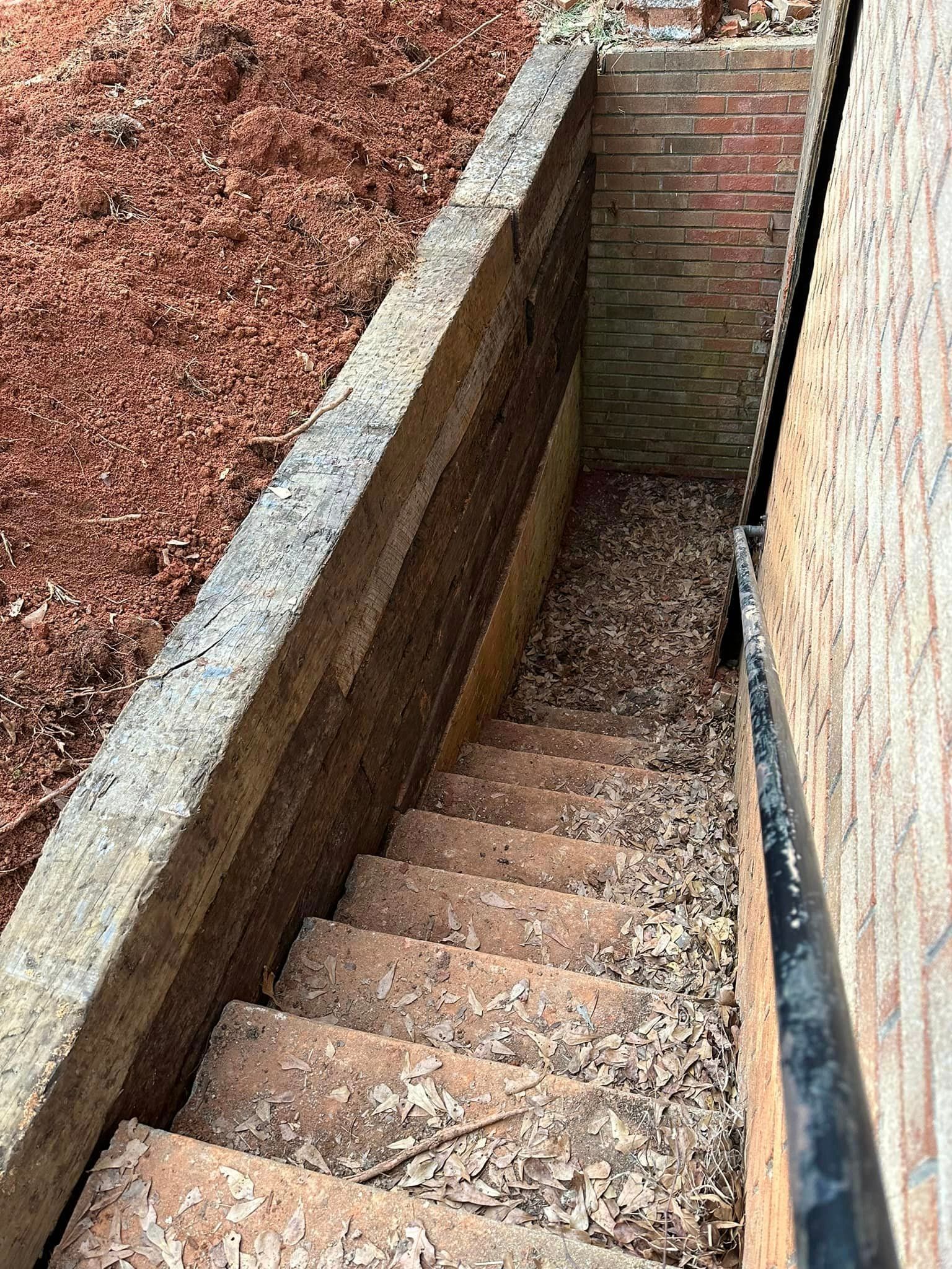 A set of stairs leading up to a brick wall.