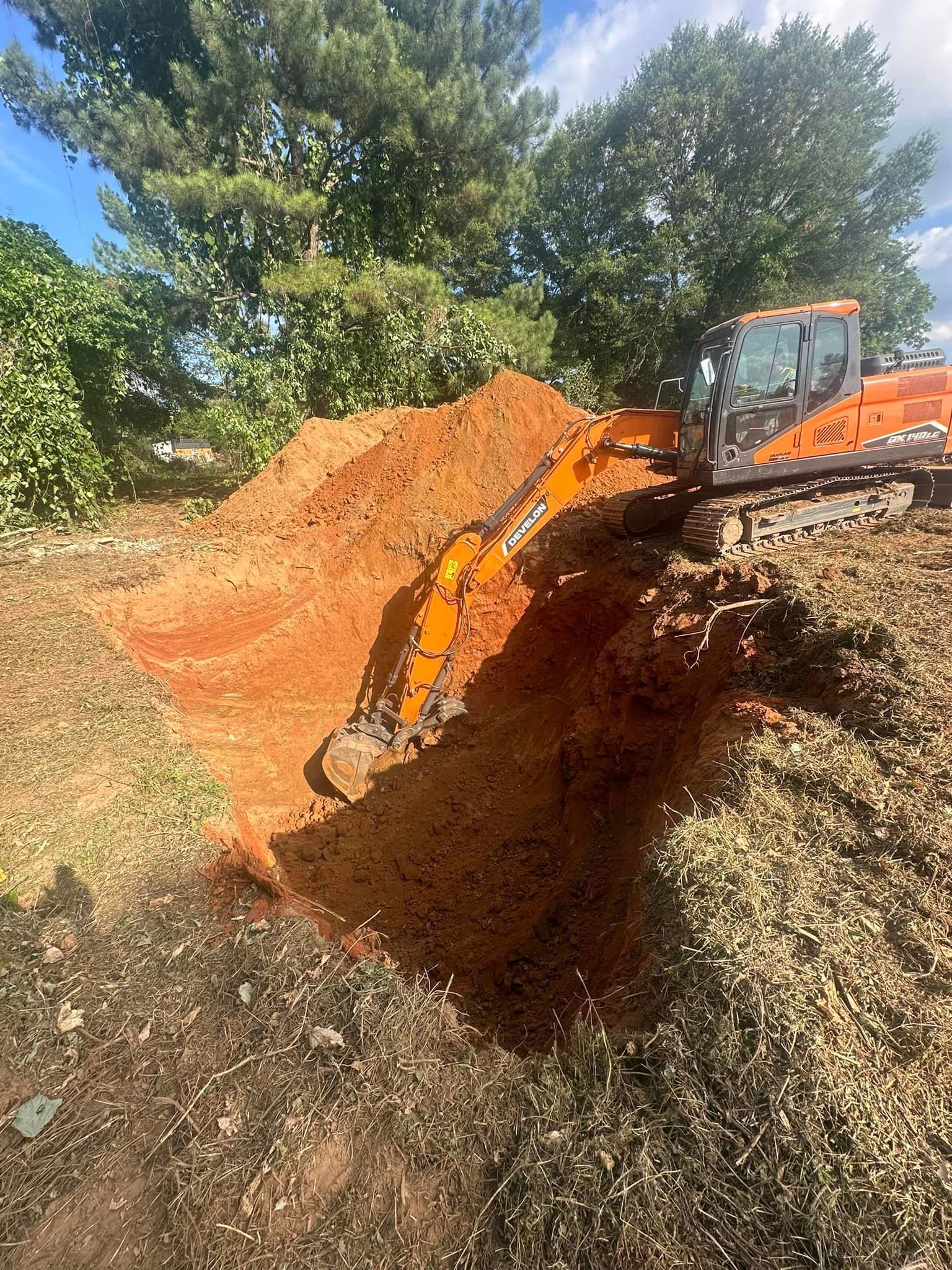 A bulldozer is digging a hole in the ground in a field.