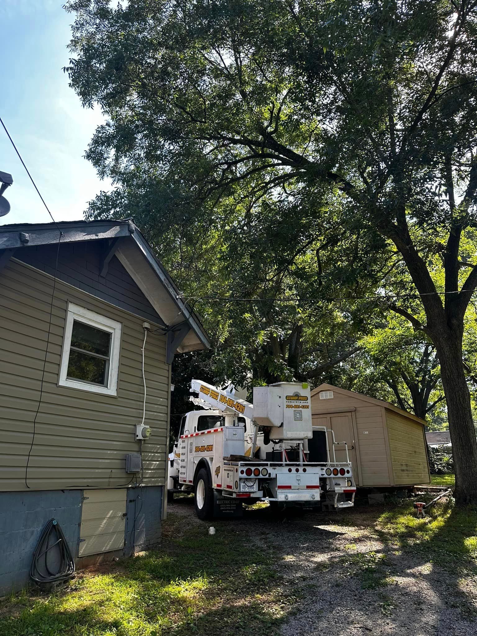 A white truck is parked in front of a house.