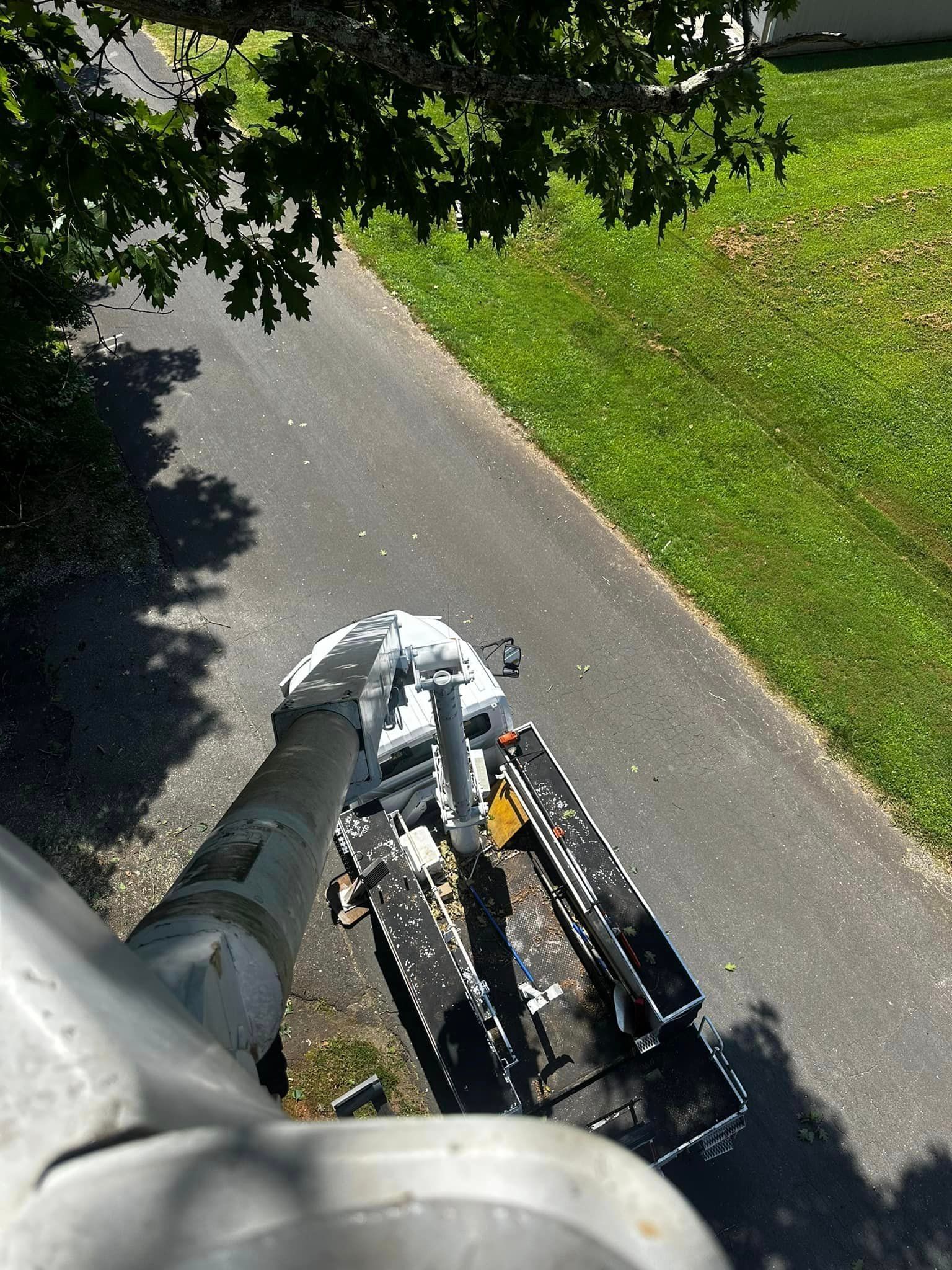 An aerial view of a crane on the side of a road.