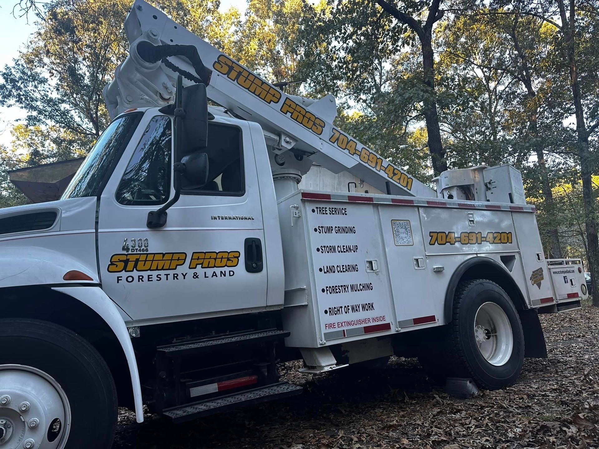 A stump pro truck is parked in the woods