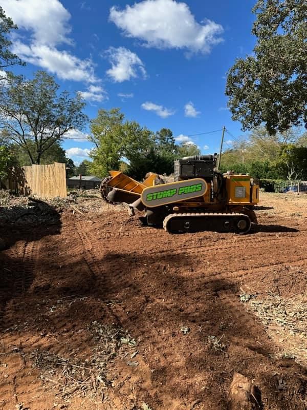 A bulldozer is sitting in the middle of a dirt field.