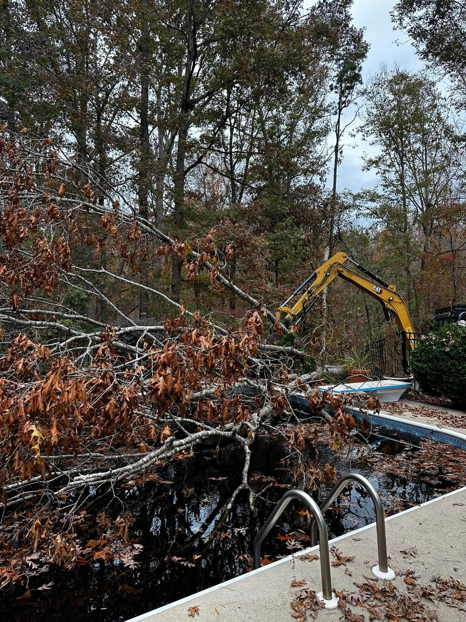 A large yellow excavator is working on a swimming pool.
