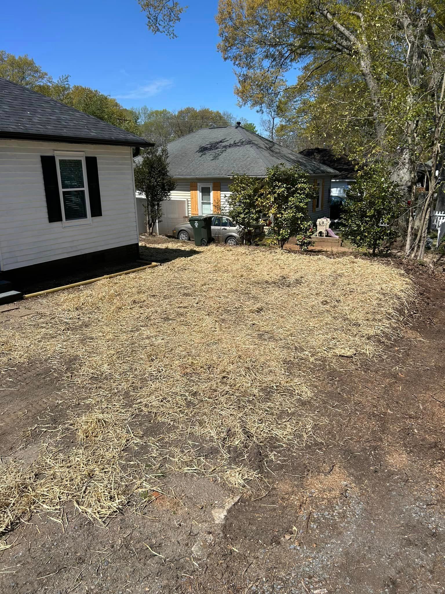 A house with a lot of gravel in front of it.