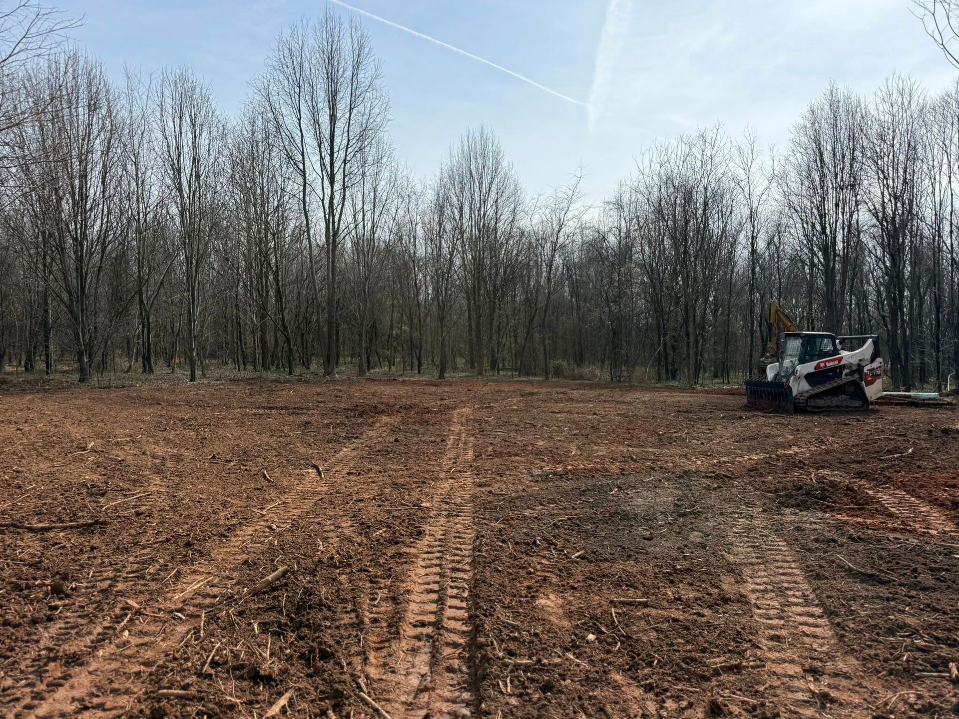 A stump grinder is sitting next to a tree stump in a yard.