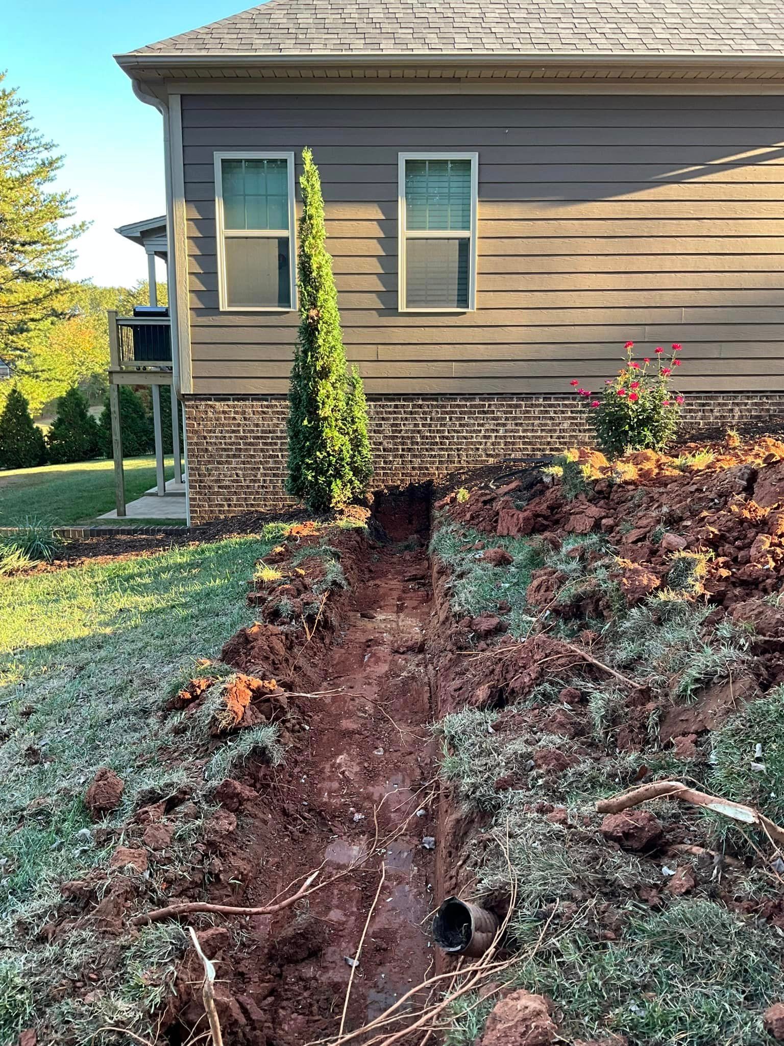 A house with a lot of dirt in front of it.