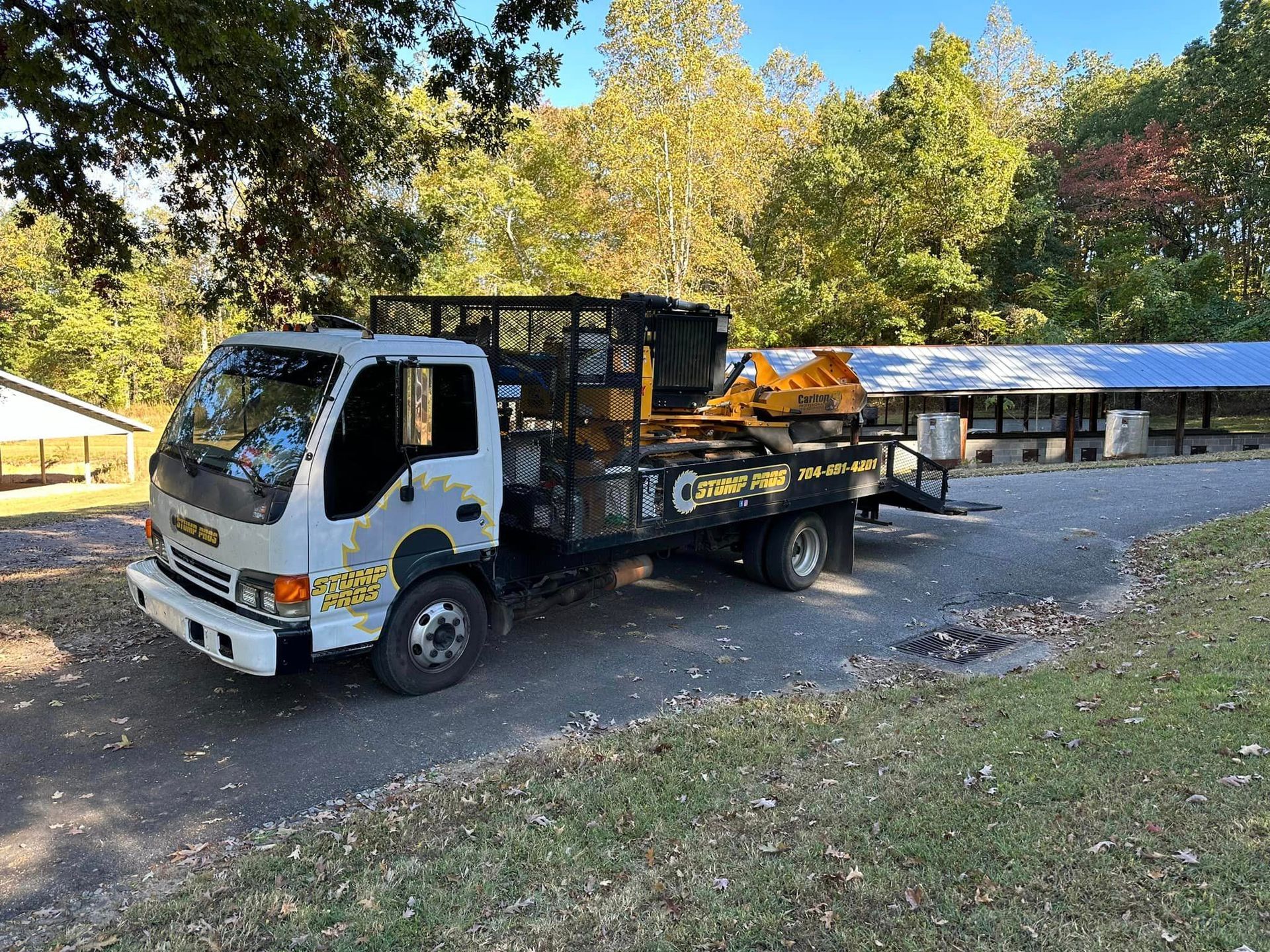 A tow truck is parked on the side of the road next to a building.