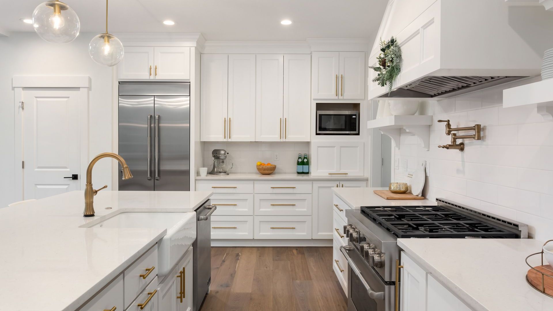 A kitchen with white cabinets and stainless steel appliances.