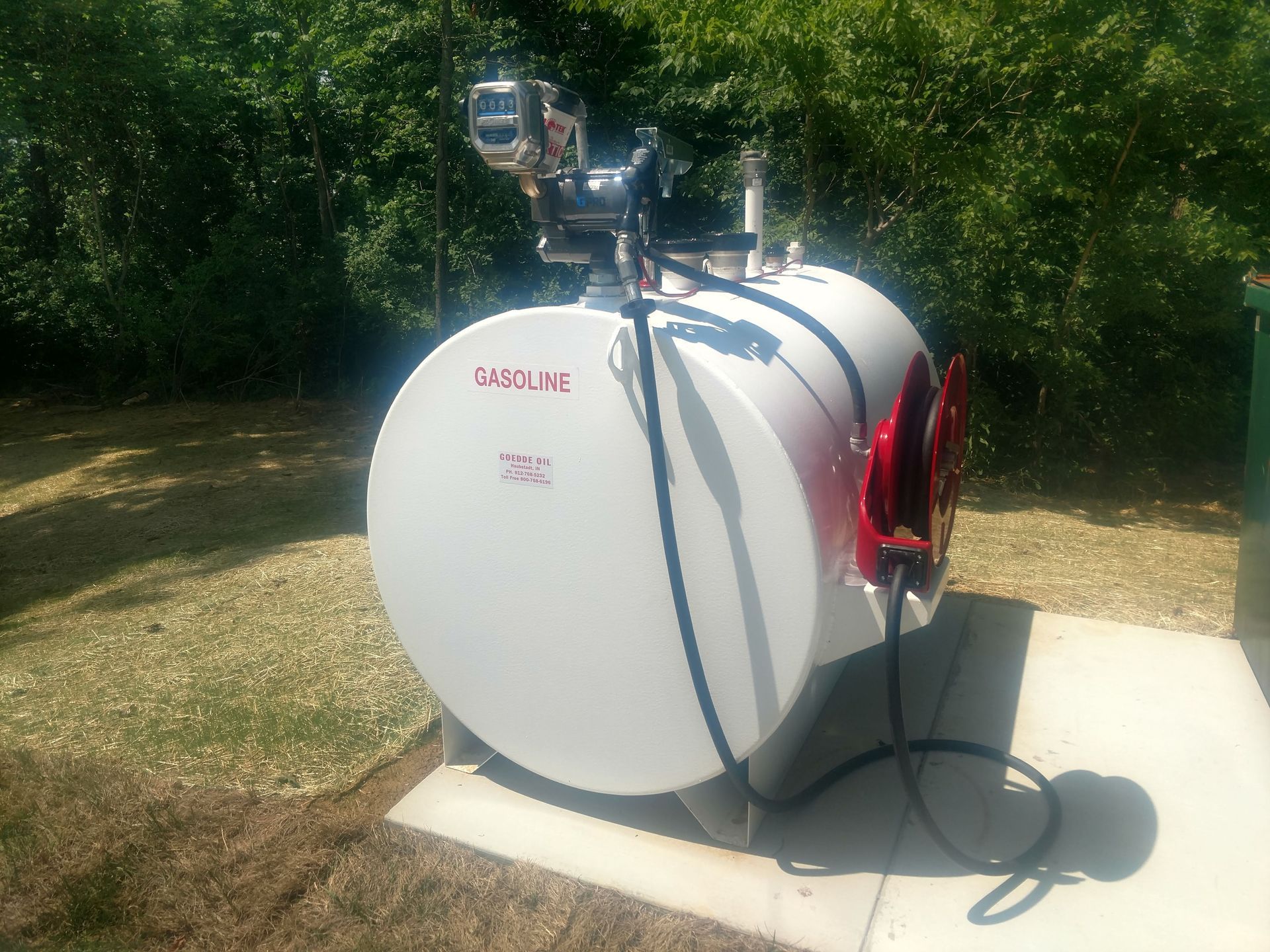 A large white tank with a pump attached to it