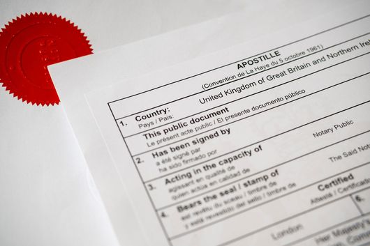 Apostille document with a red seal, certifying an official document from the United Kingdom.