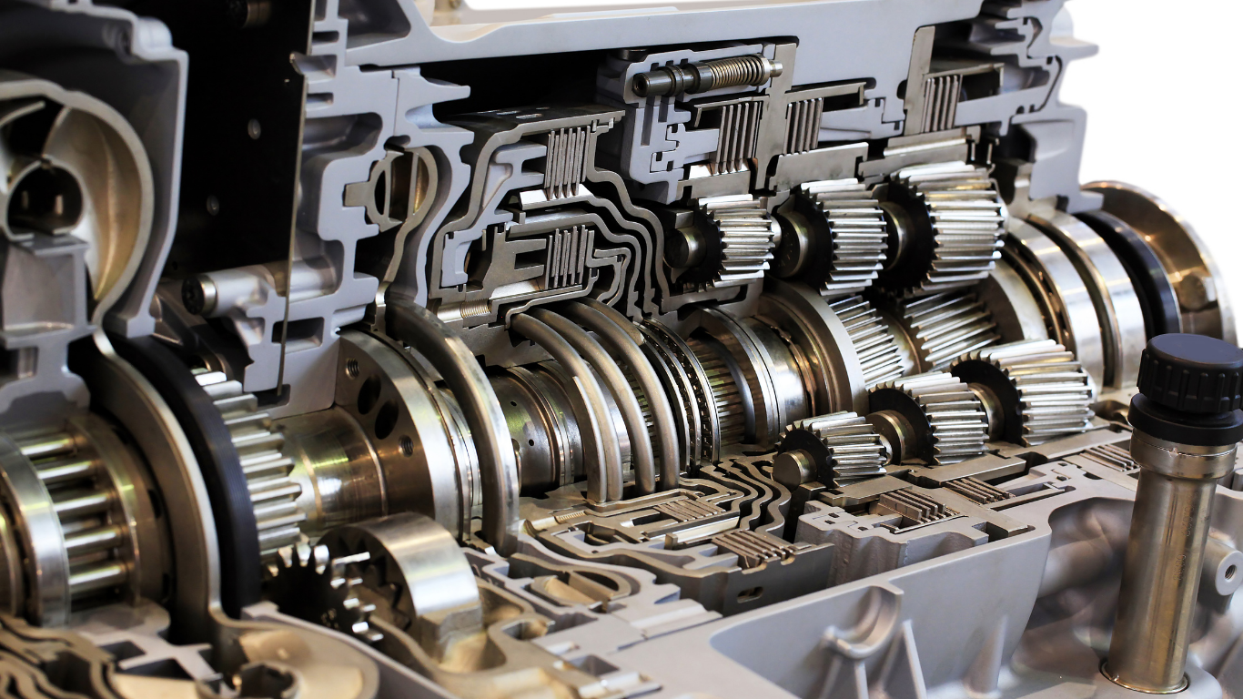 Cutaway view of a car transmission showing gears, shafts, and hydraulic components.