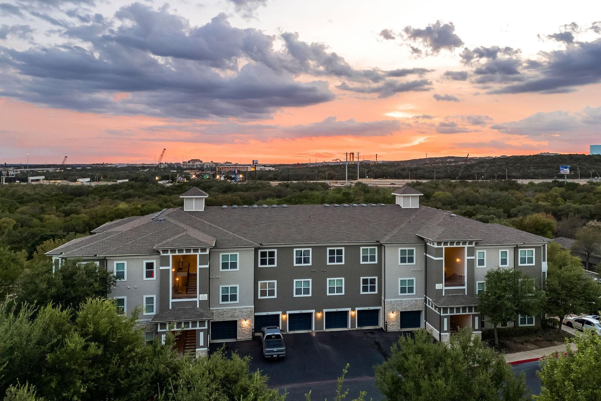 a large building with a sunset in the background