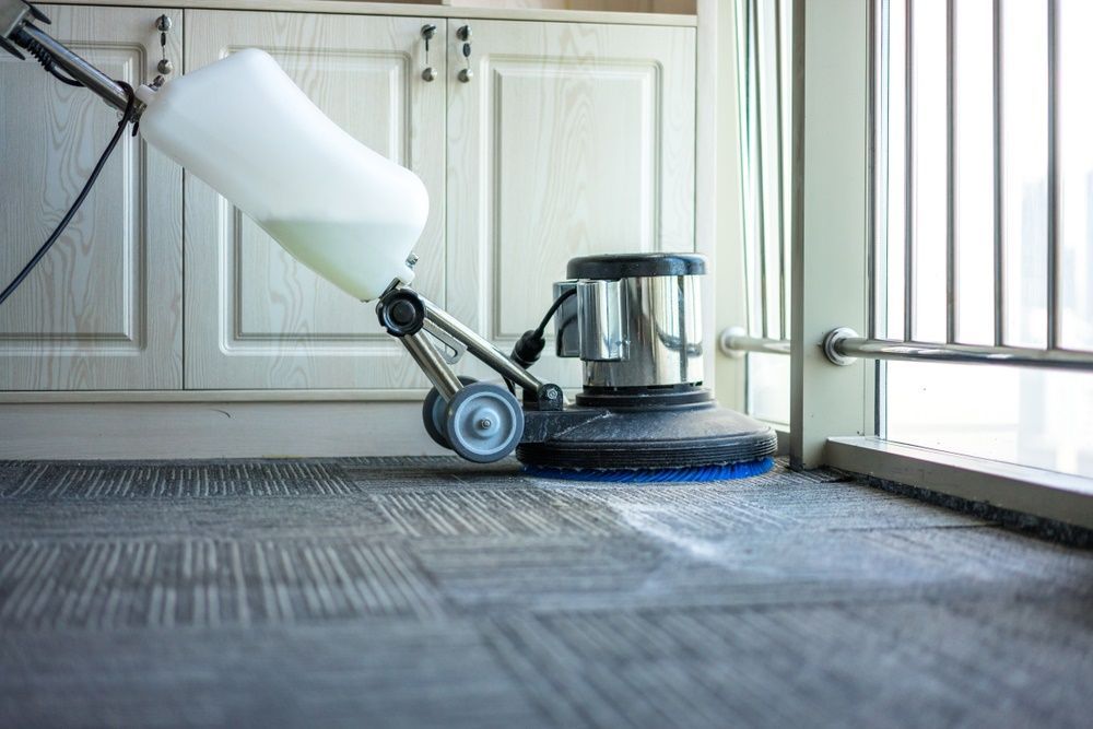 A Vacuum Cleaner Is Cleaning A Carpet In A Room — Sadie's Cleaning Services in Koongal, QLD