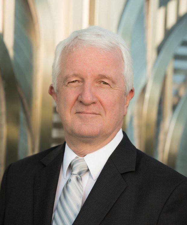 Silhouette of a person in a suit and tie, head and shoulders.