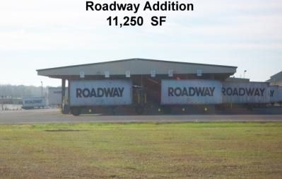 Roadway trucking facility with three Roadway containers under a loading bay.