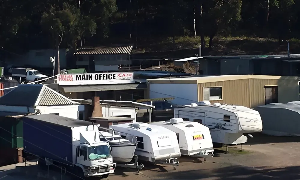 A Row of Trailers Are Parked in Front of a Building That Says Main Office — Teralba Business & Storage Park in Teralba, NSW