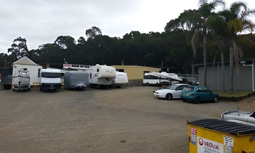 A Green Shed in a Garden With a Cobblestone Path Leading to It — Teralba Business & Storage Park in Teralba, NSW