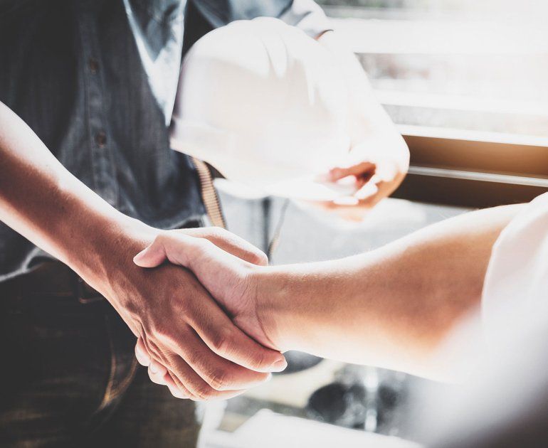 Workers Compensation — Two Men Shaking Hands In Moline, IL