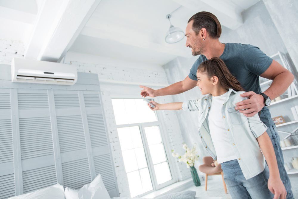 Father and daughter are testing their new energy-efficient air conditioner