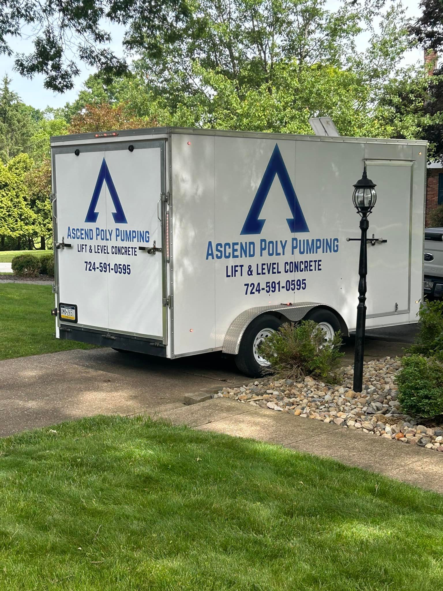 White trailer with blue logo,