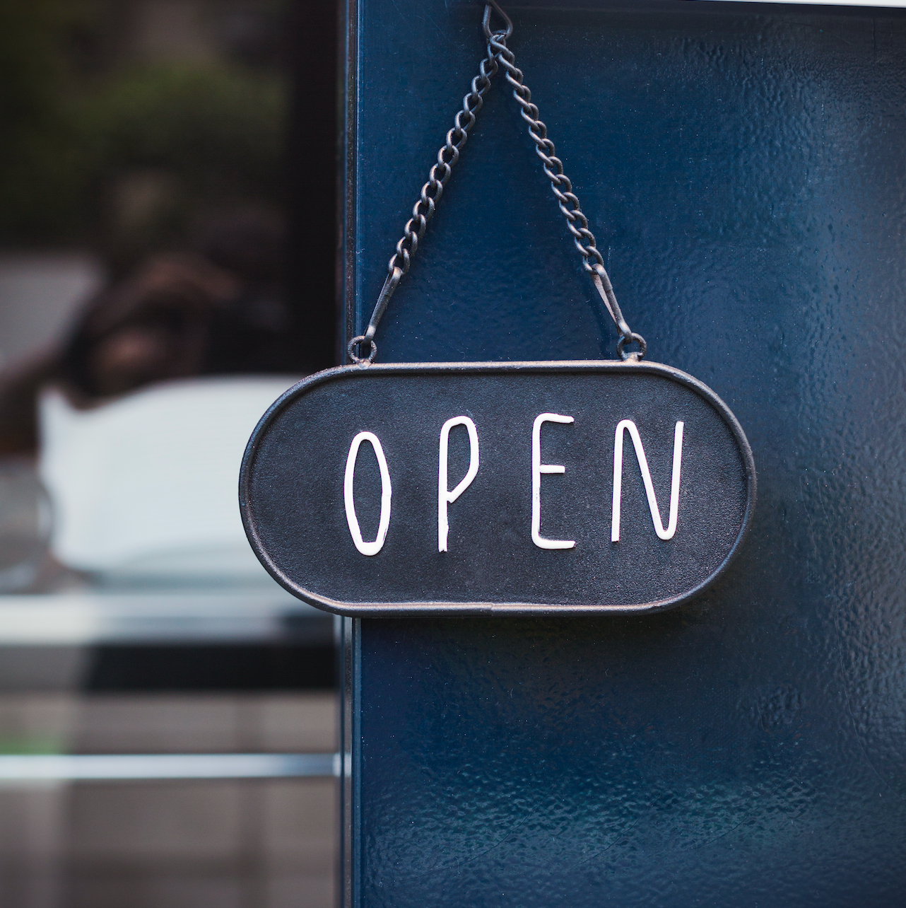 Sign hanging on business door says 