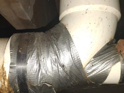 A close up of a pipe wrapped in duct tape.