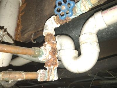 A close up of a pipe with a blue valve on it