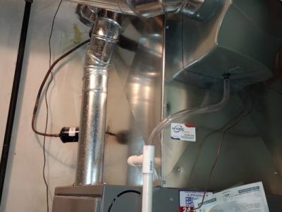 A picture of an air conditioner in a basement.