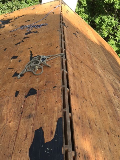 Wooden rooftop with attached ladder and rope, possibly for climbing or maintenance.